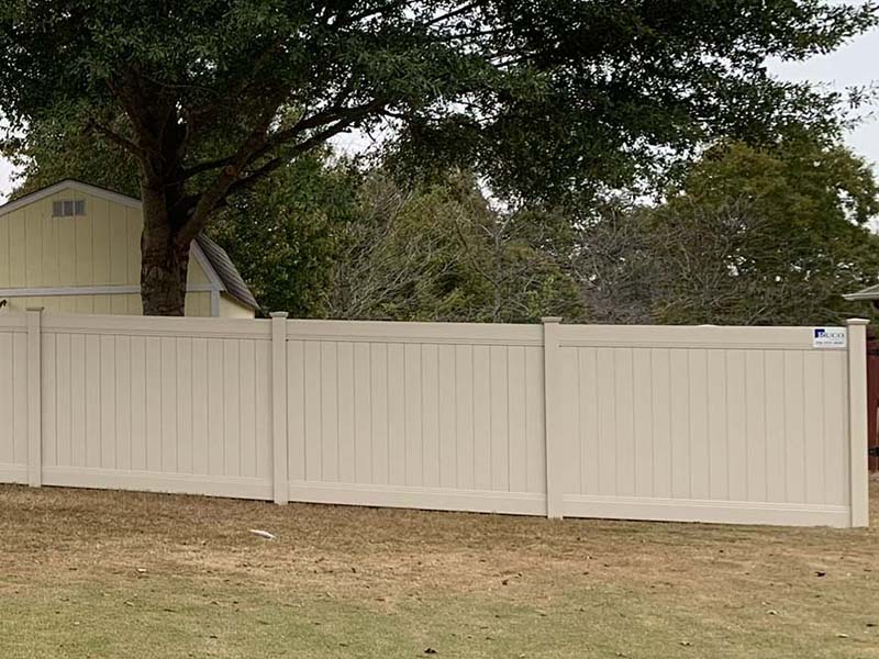 Tan vinyl residential privacy fence in Huntsville Alabama